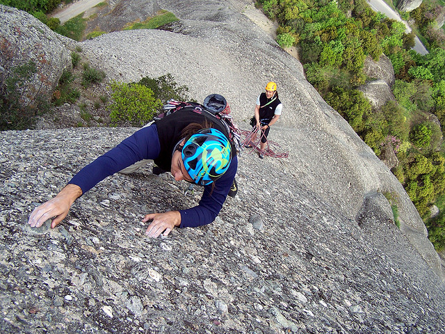 A man rock climbing with a helmet